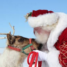 Santa giving reindeer kisses