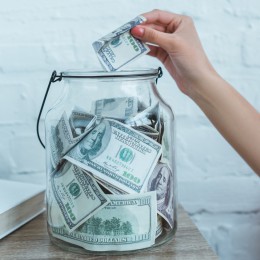 Photo of cash in glass jar