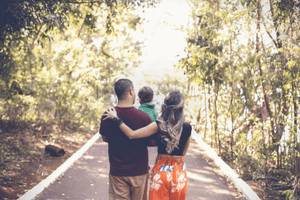 Image of young family walking in woods